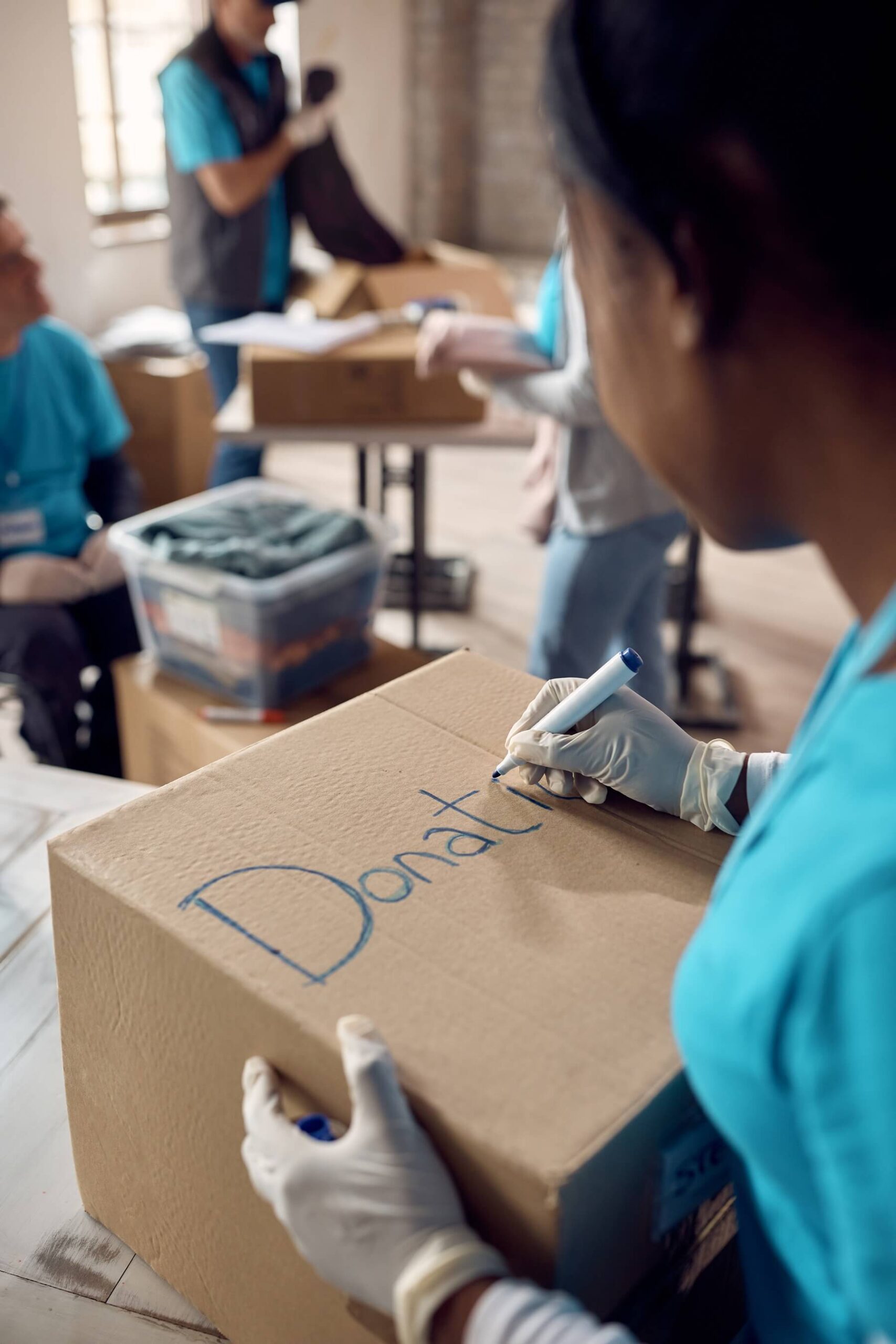 close-up-of-woman-marking-donation-boxes-while-vol-2022-11-16-14-40-42-utc.jpg